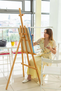 Woman painting at home