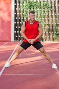 Portrait of young woman exercising on court