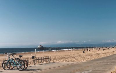 Bicycle on beach against sky