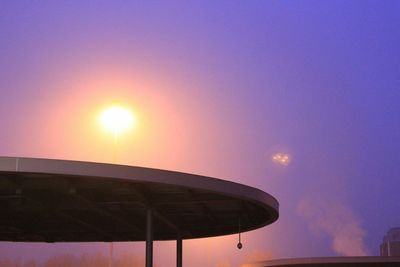 Low angle view of built structures at sunset