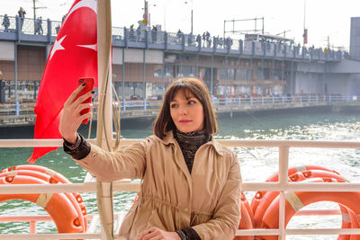 Woman taking selfie in yacht