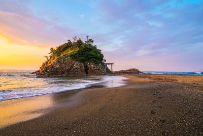 Scenic view of beach against sky during sunset