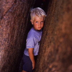 Portrait of boy standing by wall