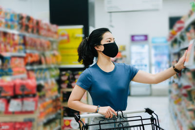 Young woman looking up at store