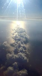 Aerial view of sea against cloudy sky