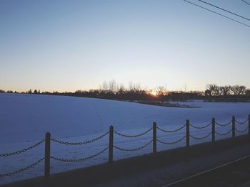 Scenic view of river against clear sky during winter