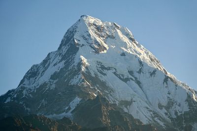 Low angle view of snowcapped mountain against sky