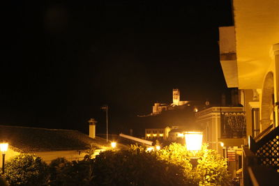 Illuminated city against sky at night