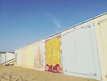 Low angle view of built structure on beach against sky