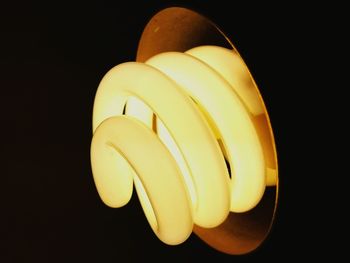 Close-up of illuminated lamp over black background