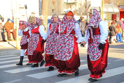 Group of people walking on street in city