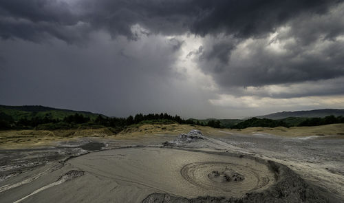 Storm clouds over mud volcanoes 