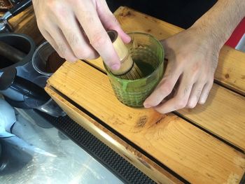 Midsection of person preparing food on cutting board