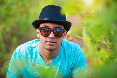 Portrait of young man wearing sunglasses standing outdoors