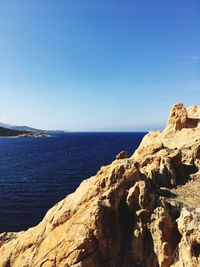 Scenic view of sea against clear blue sky