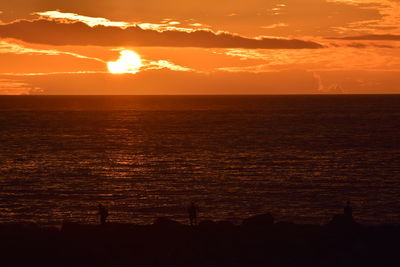 Scenic view of sea against orange sky