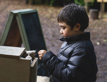 Side view of boy looking at camera