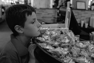 Boy looking at food in market