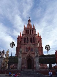 Low angle view of building against cloudy sky