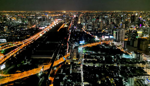 High angle view of illuminated city buildings at night