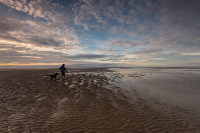 Dog walk on old hunstanton beach at sunset