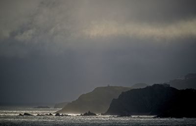 Scenic view of sea against stormy sky