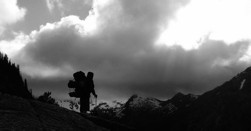 Scenic view of mountains against cloudy sky