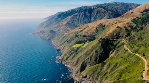 High angle view of sea and mountains against sky