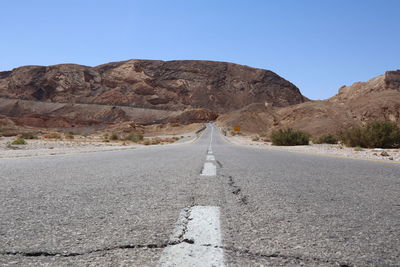 Asphalt gray road for car under blue sky in the desert way wasteland during journey to eilat breaks
