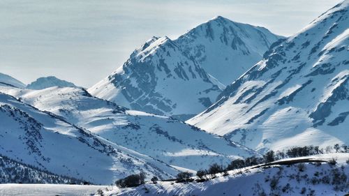 Scenic view of snow covered mountains against sky