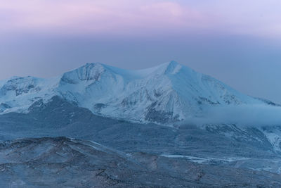 Scenic view of snowcapped mountains against sky during winter