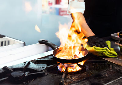 Cropped hand of man preparing food