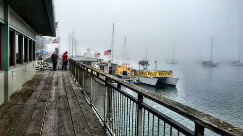 Boats moored at harbor during winter