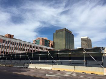 Empty road against buildings