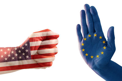 Cropped hands with flag pattern gesturing against white background