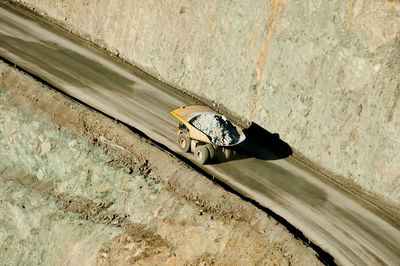 High angle view of motorcycle on road against wall