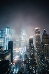 High angle view of city lit up at night