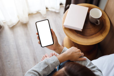 Midsection of woman using mobile phone