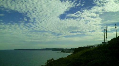 Scenic view of sea against cloudy sky