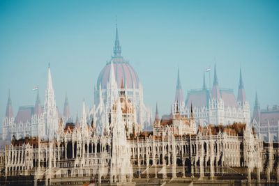 Double exposure of hungarian parliament building and church