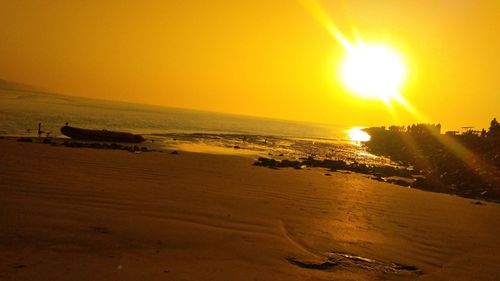 Scenic view of beach against sky during sunset