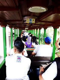 Rear view of people sitting in corridor