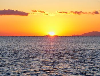 Scenic view of sea against orange sky