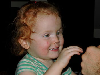 Close-up of cute smiling girl at home