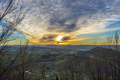 Scenic view of field against sky during sunset