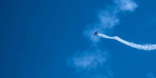 Low angle view of airplane flying in sky