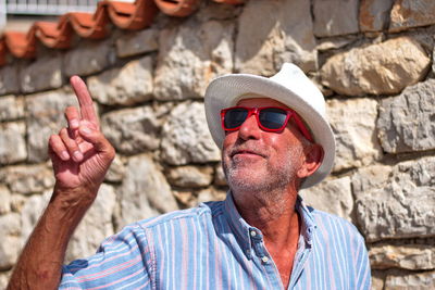 Portrait of man wearing sunglasses standing outdoors