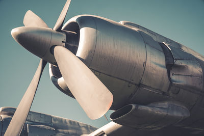 Low angle view of airplane flying against sky