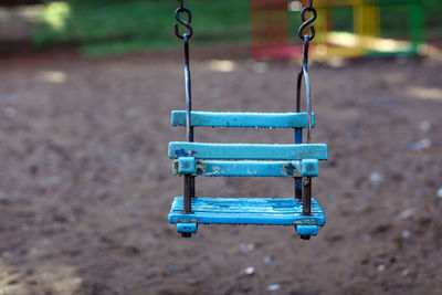 Empty baby swing hanging at playground