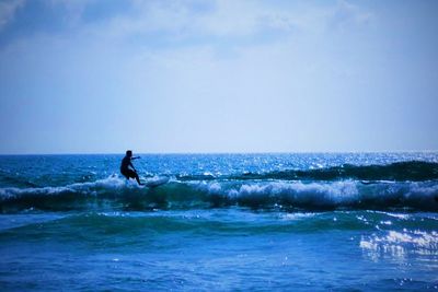 People surfing in sea